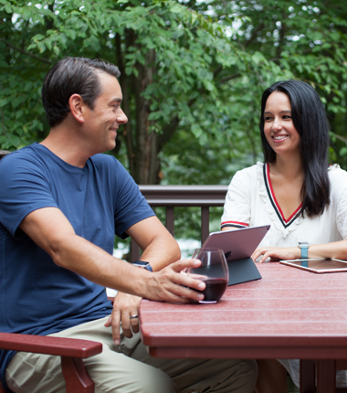 Clayton Morris and Natali Morris sit together at a table outside